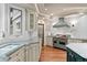 Gourmet kitchen with custom cabinets, marble counters, and high-end appliances at 11406 Conifer Ridge Dr, Conifer, CO 80433