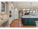 Spacious kitchen features a large island with marble countertop and hardwood flooring at 11406 Conifer Ridge Dr, Conifer, CO 80433
