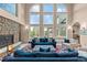 A cozy living room showcases a stone fireplace and expansive windows with natural light at 11406 Conifer Ridge Dr, Conifer, CO 80433