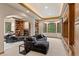 Spacious living room with built-in bookshelves, fireplace, and large windows for natural light at 11406 Conifer Ridge Dr, Conifer, CO 80433