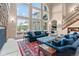 Spacious living room featuring a stone fireplace, cathedral windows and hardwood floors at 11406 Conifer Ridge Dr, Conifer, CO 80433