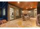 Covered patio with stone flooring, fireplace, and furniture at 11406 Conifer Ridge Dr, Conifer, CO 80433
