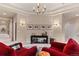 Sitting room with chandelier, console table and reading chairs at 11406 Conifer Ridge Dr, Conifer, CO 80433