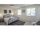 Sunlit bedroom with cozy bed, two windows, and tasteful decor creates a restful retreat at 13833 W 68Th Ave, Arvada, CO 80004