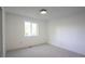 This light-filled bedroom features neutral carpet and a window at 13833 W 68Th Ave, Arvada, CO 80004