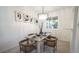 Elegant dining room with a modern chandelier, stylish artwork, and seating for four, perfect for intimate meals at 13833 W 68Th Ave, Arvada, CO 80004