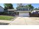 Charming two-story home with a well-maintained front yard and a spacious two car garage at 13833 W 68Th Ave, Arvada, CO 80004