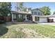 Charming two-story home with a well-maintained lawn, brick accents, and an attached two-car garage at 13833 W 68Th Ave, Arvada, CO 80004