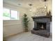 A cozy brick fireplace with a decorative mantel and modern lighting at 13833 W 68Th Ave, Arvada, CO 80004