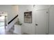 Entry hallway featuring modern art, neutral decor, and seamless transition to living spaces at 13833 W 68Th Ave, Arvada, CO 80004