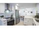 Bright kitchen featuring stainless steel appliances, white cabinetry, and modern finishes for a clean and stylish look at 13833 W 68Th Ave, Arvada, CO 80004