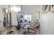 Open-concept living space combining dining and living areas with modern decor and ample natural light from large windows at 13833 W 68Th Ave, Arvada, CO 80004