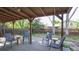 This covered patio features a wood deck and outdoor furniture at 13833 W 68Th Ave, Arvada, CO 80004