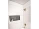 Sleek shower with white tile, built-in niche, and elegant fixtures at 13833 W 68Th Ave, Arvada, CO 80004