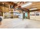 Unfinished basement offers a blank canvas with exposed beams, storage cabinets, and a vintage fridge and freezer combo at 7948 Stuart St, Westminster, CO 80030