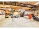 Spacious unfinished basement featuring concrete floors, exposed beams, built-in shelving, and utility access for convenience at 7948 Stuart St, Westminster, CO 80030