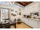 Well-lit kitchen and dining space featuring hardwood floors and ample storage cabinets at 7948 Stuart St, Westminster, CO 80030