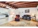 Comfortable living room adjacent to kitchen, with a warm exposed wood beam ceiling at 7948 Stuart St, Westminster, CO 80030