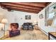 Bright living room with exposed beam ceiling, providing a warm and inviting atmosphere at 7948 Stuart St, Westminster, CO 80030
