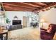Cozy living room showcasing vaulted ceilings, an adjacent kitchen/dining area, and carpet flooring at 7948 Stuart St, Westminster, CO 80030