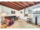 Cozy living room featuring a wood-beamed ceiling and natural light, perfect for relaxation at 7948 Stuart St, Westminster, CO 80030