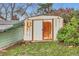 Exterior shed with double doors, and rust is on the exterior with lawn and small bushes in the yard at 7948 Stuart St, Westminster, CO 80030