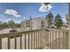 Balcony with open street views featuring parking, residential building and distant greenery at 381 S Ames St # F208, Lakewood, CO 80226