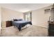Spacious bedroom features a plush carpet, air conditioning and a sliding door to a balcony at 381 S Ames St # F208, Lakewood, CO 80226