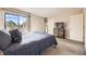Comfortable bedroom with a queen bed, balcony access, and plenty of natural light at 381 S Ames St # F208, Lakewood, CO 80226