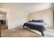 Bright bedroom with a queen bed, soft carpet, and easy access to additional rooms at 381 S Ames St # F208, Lakewood, CO 80226