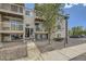 Charming building entrance with stone accents and well-maintained landscaping at 381 S Ames St # F208, Lakewood, CO 80226