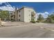 Exterior view of the building with private balconies and manicured landscaping at 381 S Ames St # F208, Lakewood, CO 80226