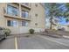 Building exterior featuring multiple balconies, siding and convenient parking area at 381 S Ames St # F208, Lakewood, CO 80226