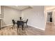Bright dining area features light wood floors, a glass top table, and seating for four at 381 S Ames St # F208, Lakewood, CO 80226
