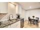 Bright kitchen features stainless steel appliances, granite countertops, and a cozy dining area at 381 S Ames St # F208, Lakewood, CO 80226