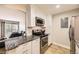 The kitchen features a stainless steel oven, subway tile backsplash, and granite countertops at 381 S Ames St # F208, Lakewood, CO 80226