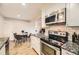 Bright kitchen features stainless steel appliances, granite countertops, and a cozy dining area at 381 S Ames St # F208, Lakewood, CO 80226