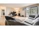 Spacious living room features a fireplace, balcony access, and ample natural light at 381 S Ames St # F208, Lakewood, CO 80226