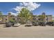 Exterior view of the building, surrounded by a parking lot at 381 S Ames St # F208, Lakewood, CO 80226