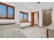 Bright bathroom featuring a soaking tub, tiled floors, and glass shower at 6980 Oak St, Arvada, CO 80004