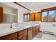 Bathroom with long vanity, double sinks and bright lighting at 6980 Oak St, Arvada, CO 80004