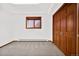 Bedroom featuring neutral carpet, white walls, natural lighting, and wood closet at 6980 Oak St, Arvada, CO 80004