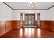 Dining area enhanced with wood wall trim, a chandelier, and bay window at 6980 Oak St, Arvada, CO 80004