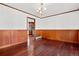 Formal dining room featuring hardwood floors, wainscoting, and a chandelier at 6980 Oak St, Arvada, CO 80004