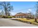 Attached three car garage with brick exterior and mature trees in the front yard at 6980 Oak St, Arvada, CO 80004