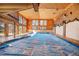 Indoor pool and hot tub with vaulted ceilings and wood paneling at 6980 Oak St, Arvada, CO 80004