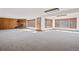 Bright living room with a brick fireplace and a wall of windows, filling the space with natural light at 6980 Oak St, Arvada, CO 80004