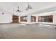 Living room features a brick fireplace, large windows, and an open layout for seamless entertaining at 6980 Oak St, Arvada, CO 80004