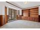 Library or living area with wall of built-in shelving, large windows, and wood trim at 6980 Oak St, Arvada, CO 80004