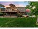 Spacious backyard featuring a wooden deck with umbrella and a patio, perfect for entertaining at 1758 Parkdale N Cir, Erie, CO 80516